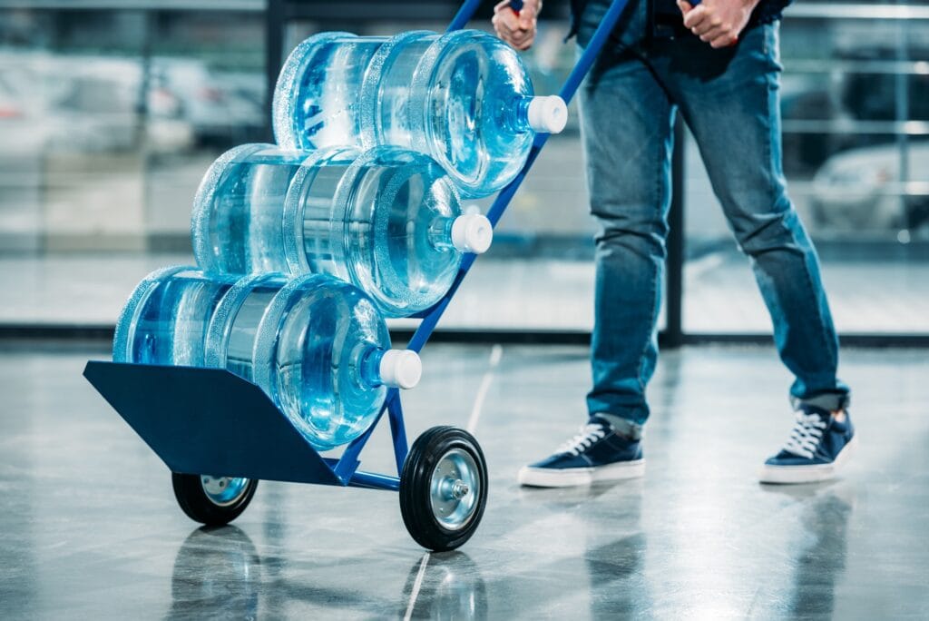 loader-pushing-cart-with-water-bottles-1024x684